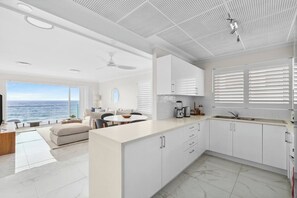 Cook up a feast in the fully equipped kitchen, complete with an oven, coffee maker, and spacious island bench—perfect for prepping beachside snacks or enjoying a lazy morning with a fresh brew.
