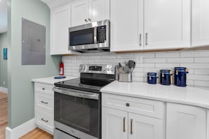 Sleek stainless steel appliances, including electric stove