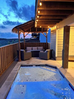 At night, our poolside covered palapas glow with party lights — a cozy love seat and cushioned chairs invite you to unwind and soak in the magic under the stars.