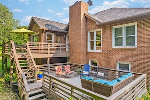 Spacious lower patio with plenty of outdoor seating and beautiful views of the private, wooded backyard.