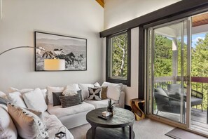 Elegant living room with beautiful views, fireplace, and large smart TV