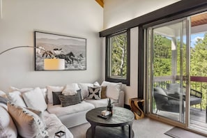 Elegant living room with beautiful views, fireplace, and large smart TV