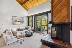 Elegant living room with beautiful views, fireplace, and large smart TV