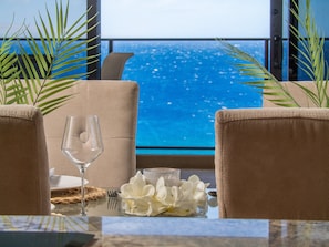 Enjoy a romantic meal or family dinner with ocean views from the dining area—perfect for sunset dinners in this luxury Maui beachfront condo.