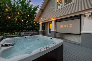 Hot Tub & Movie Night Combo: Enjoy movie nights under the stars with our outdoor projector screen, relax in the bubbling hot tub, and unwind on a cozy patio surrounded by trees—your private backyard retreat!