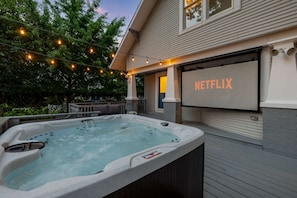 Hot Tub & Movie Night Combo: Enjoy movie nights under the stars with our outdoor projector screen, relax in the bubbling hot tub, and unwind on a cozy patio surrounded by trees—your private backyard retreat!