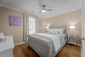 Cozy bedroom with queen bed and smart TV for relaxation and entertainment.