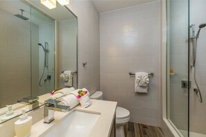 Full bathroom with walk-in shower, make up cloths, shampoo, conditioner and body wash.