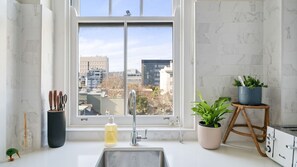 Morning light and city views from the kitchen sink.