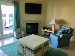 This stylish living room boasts a warm ambiance with a fireplace and modern amenities, creating the ideal backdrop for your beach getaway.