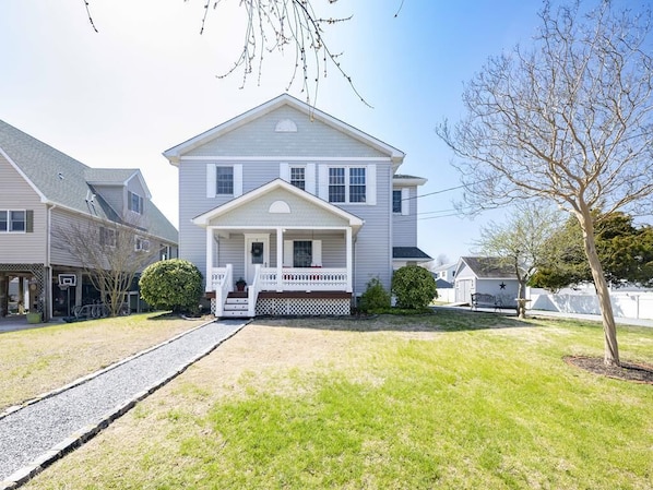 This charming six-bedroom home boasts a spacious front yard, perfect for enjoying warm evenings and close proximity to beautiful Cape May Beach.