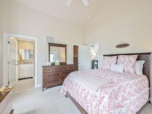 Spacious bedroom with queen bed and cozy ambiance—perfect for winding down after beach days.
