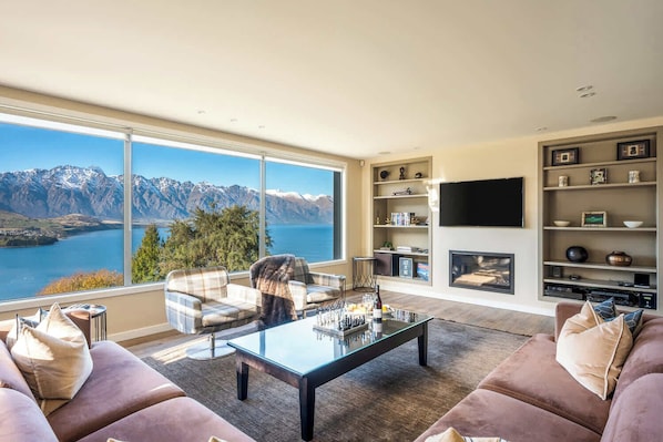 Stylish furnishings and natural light create a welcoming atmosphere in the living area. It’s an ideal spot to enjoy quality time or simply take in the breathtaking scenery.