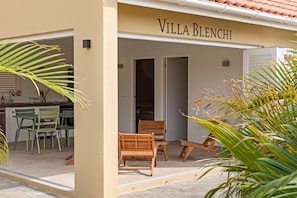 Villa Blenchi offers folding shutter doors, an open-plan kitchen, and spacious terraces surrounded by lush tropical greenery. Enjoy seamless indoor-outdoor living perfect for relaxing in the Curaçao sun.