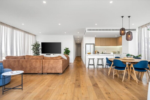 Open plan kitchen living and dining with private deck and views