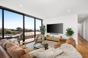 Open plan kitchen living and dining with private deck and views