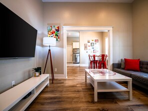 Living Room: Smart TV, Couch for 3, and 2 comfy chairs