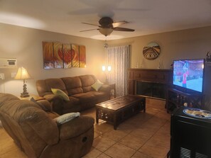 Living room has two couches and a smart TV with YouTube TV.