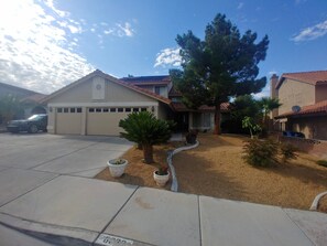 View of front yard.  Mature tree provides shade and privacy.  
