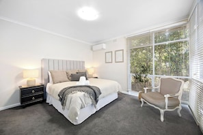 Main bedroom with garden views and split system heating and cooling