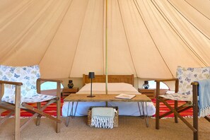 Each tent includes a double bed and two chairs, with two additional airbeds available on request.