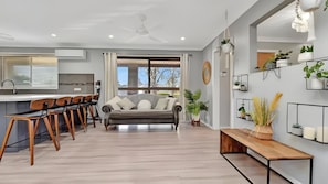 Comfy sofa and stylish kitchen seating.