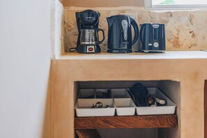 A full coffee and tea station with kettle, coffee maker, and storage for all your brewing essentials.


