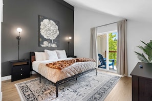 Recharge in the elegant king bedroom, showcasing a smart TV & deck access