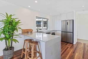 Fully equipped kitchen with modern appliances, ready for home-cooked meals.