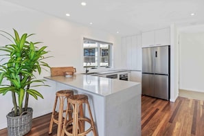 Fully equipped kitchen with modern appliances, ready for home-cooked meals.