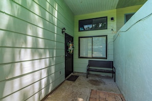 3. Walkway to entrance of CONDO 2847. Bench at front. Security camera present