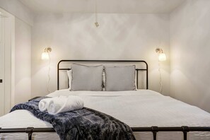 This cozy bedroom features a plush king bed framed by warm sconces—perfect for winding down after a day of exploring or relaxing indoors...







