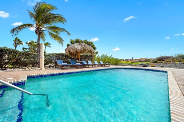 Soak up the sun and unwind by your private pool—complete with a loungers, palm trees, and a perfect view of the golf course. This is what vacation dreams are made of!