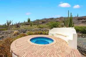 Soak, sip, and unwind—this private jacuzzi set against Aruba’s rugged hills is pure paradise.