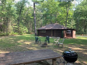 OVERALL:  The backyard at the cabin showing the fire pit, picnic table, and charcoal grill