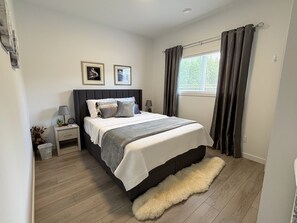 A cozy queen bed, complete with soft cotton sheets, and memory foam topper.