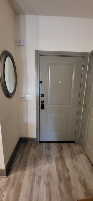 Nice secured entry foyer with large mirror. Laundry closet opposite mirror.