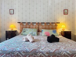 Lit king-size accueillant et douillet, avec éclairage d’appoint de chaque côté.