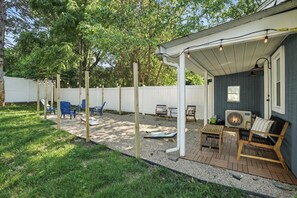 Enjoy the private backyard with string lights, cozy seating, firepit, and cornhole—perfect for relaxing evenings or family fun after visiting Valparaiso University.