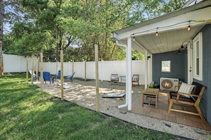 Enjoy the private backyard with string lights, cozy seating, firepit, and cornhole—perfect for relaxing evenings or family fun after visiting Valparaiso University.
