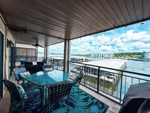 Dine al fresco or simply unwind on the expansive private balcony, offering panoramic lake views and a spacious dining table. 
