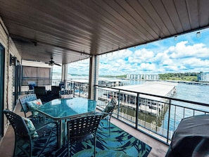Dine al fresco or simply unwind on the expansive private balcony, offering panoramic lake views and a spacious dining table.