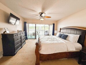 Wake up to stunning lake views from the comfortable master bedroom, offering direct access to the outdoor space.