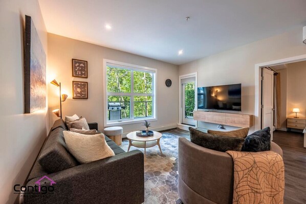 Cozy living room with smart TV (use your own streaming accounts), cable channels, and a small sofa bed. Perfect for relaxing in beautiful Golden, BC.