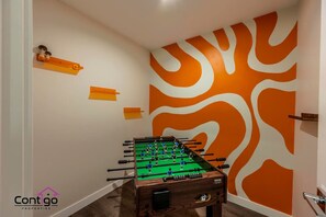 Game room with foosball table, a great space to unwind and play.