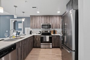 Wake up to fresh coffee in our kitchen, stocked with utensils, a dishwasher, and an oven for all your culinary needs.