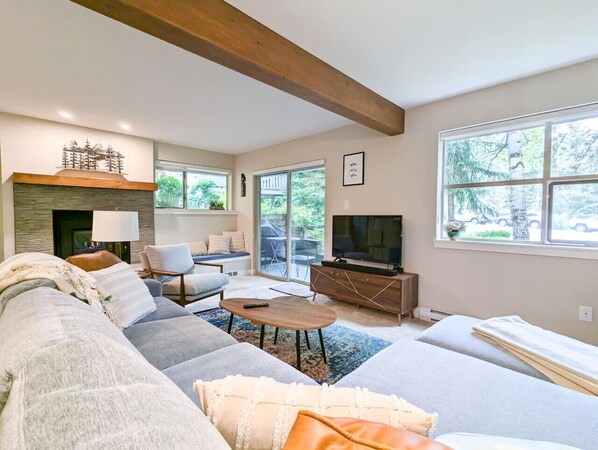 welcome to our Whistler condo! The slider door opens to a grassy outdoor area