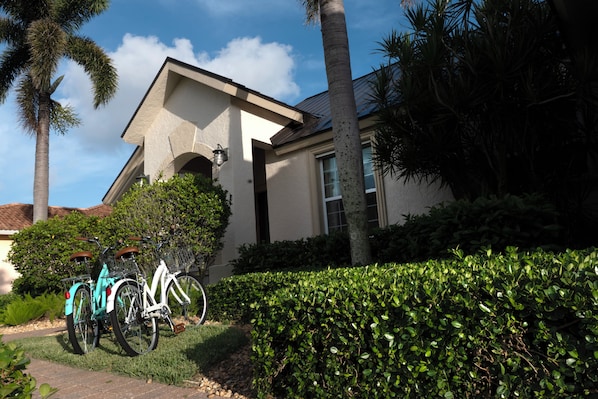 Tropical entrance with porch & bikes—perfect start to your island getaway.