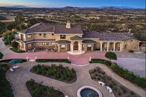 Breathtaking 25-acre property features a luxurious mansion surrounded by landscaped gardens, and offering sweeping panoramic views