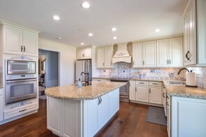Full kitchen features modern appliances, ample counter space, and all the essentials needed for cooking and dining.